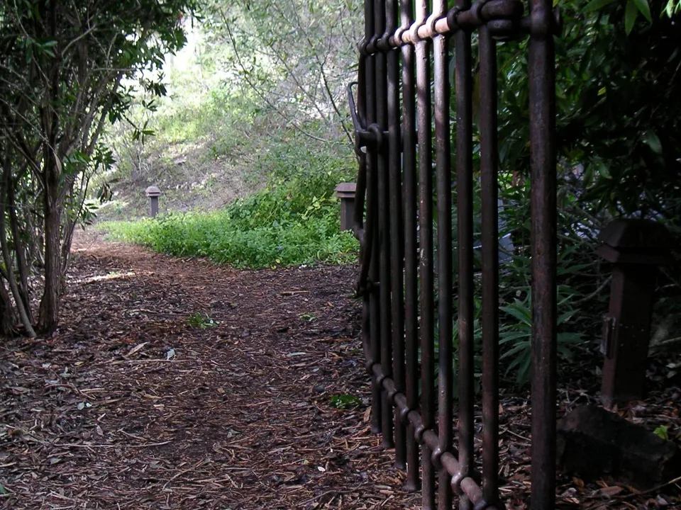 An old iron gate on a wooded path at Esalen
